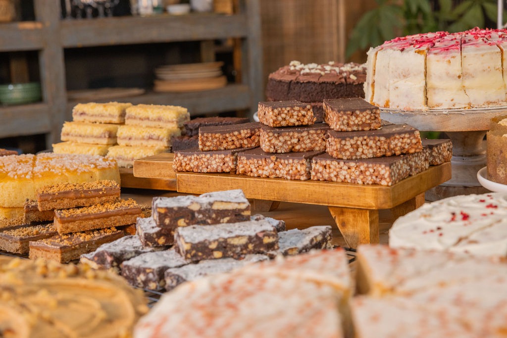 table covered in cakes and traybakes
